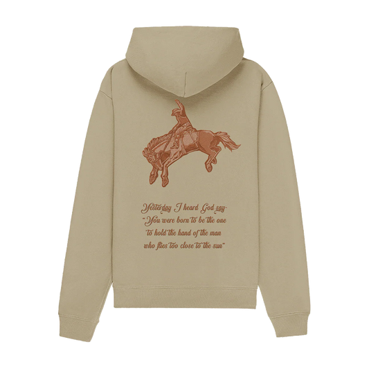 Front view of the Lana Del Rey Indio Graphic Hoodie in sand beige featuring a minimalist LDR heart logo on the chest, pullover hood, kangaroo pocket, and exclusive Indio festival-inspired merch design.
