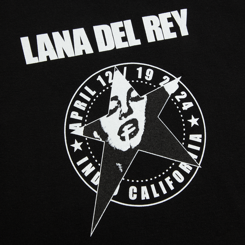Close-up detail of the Lana Del Rey Logo Black Cropped Ribbed Tank Top showcasing the white Lana Del Rey California star portrait graphic with April 12, 1924 inspired artwork printed on black ribbed fabric.