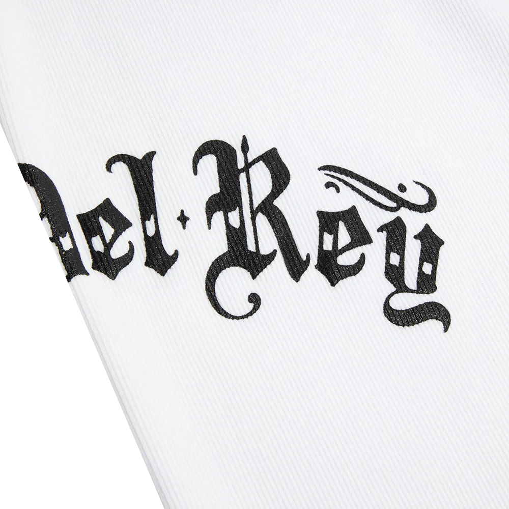 Close-up detail of the Lana Del Rey White Ribbed Print Tank Top highlighting the black gothic Lana Del Rey script printed on white ribbed fabric with vintage-inspired typography.