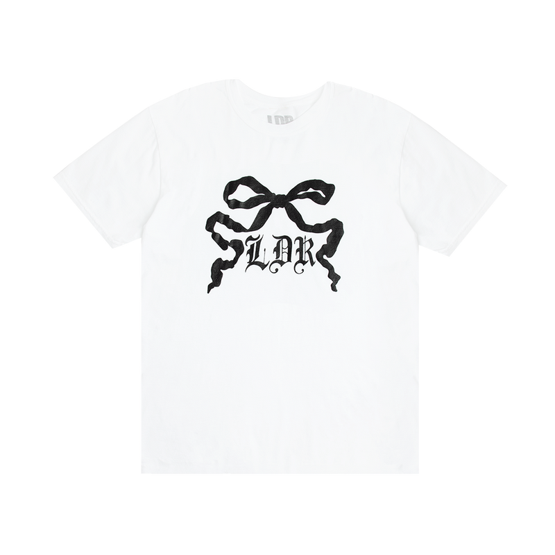 Front view of the Ribbon Graphic White T-Shirt featuring a black ribbon bow illustration with gothic LDR lettering printed on a white cotton tee inspired by Lana Del Rey's vintage romantic aesthetic.