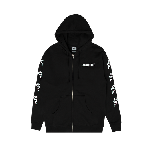 Front view of the Ribbon Sleeve Black Zip-Up Hoodie featuring a white Lana Del Rey logo on the chest, full-length zipper, kangaroo pockets, and repeating ribbon bow graphics printed down both sleeves.