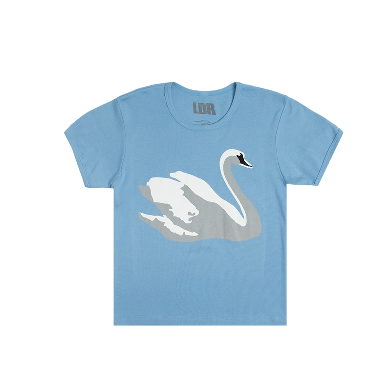 Front view of the Swan Blue Cropped T-Shirt featuring a large white swan graphic on a soft blue cropped tee inspired by Lana Del Rey's signature romantic and vintage Americana aesthetic.