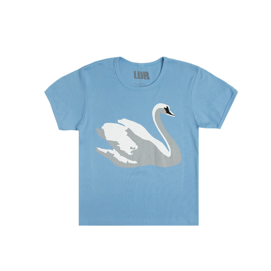 Front view of the Swan Blue Cropped T-Shirt featuring a large white swan graphic on a soft blue cropped tee inspired by Lana Del Rey's signature romantic and vintage Americana aesthetic.